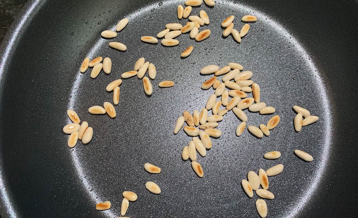 Toasted pine nuts in noser-inox pan